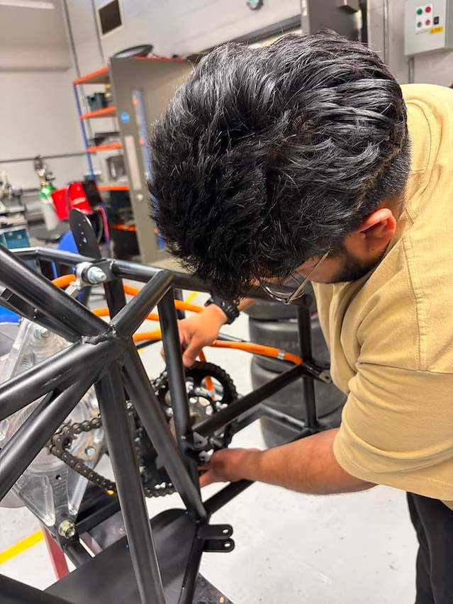 Team member assembling the car chassis